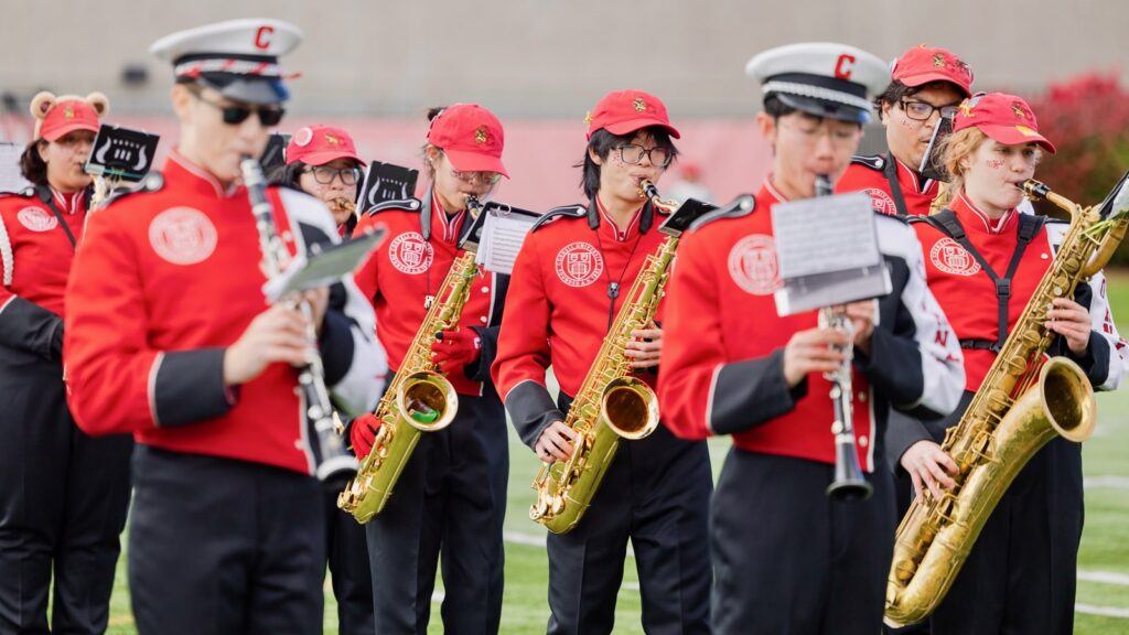 Members of the Cornell marching band play during their performance on the field.