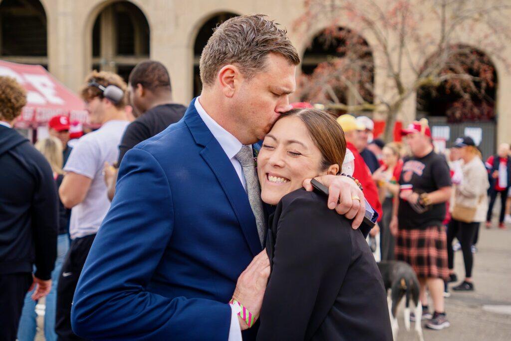 Jeffry Clausen Jr. kisses Yuko Jingu's forehead during the tailgate.