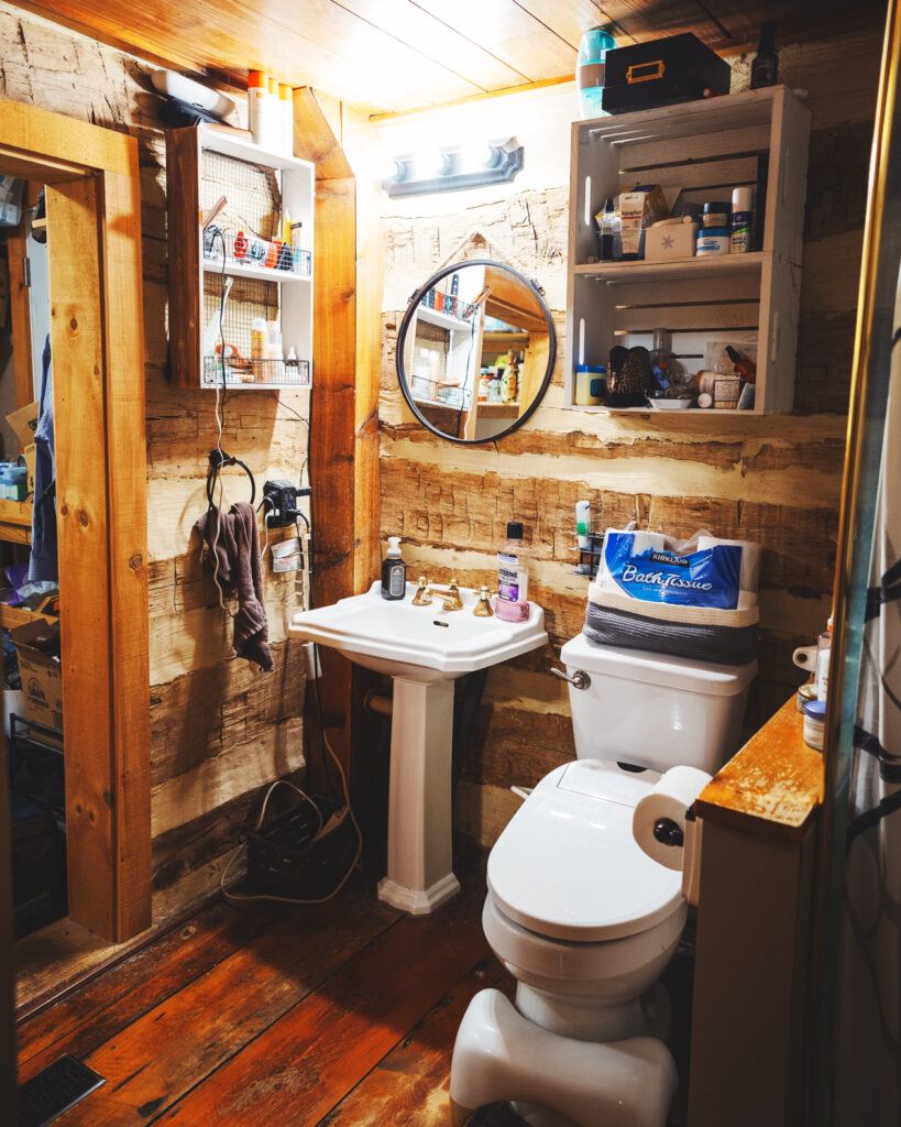 a view of the compact bathroom in the log cabin