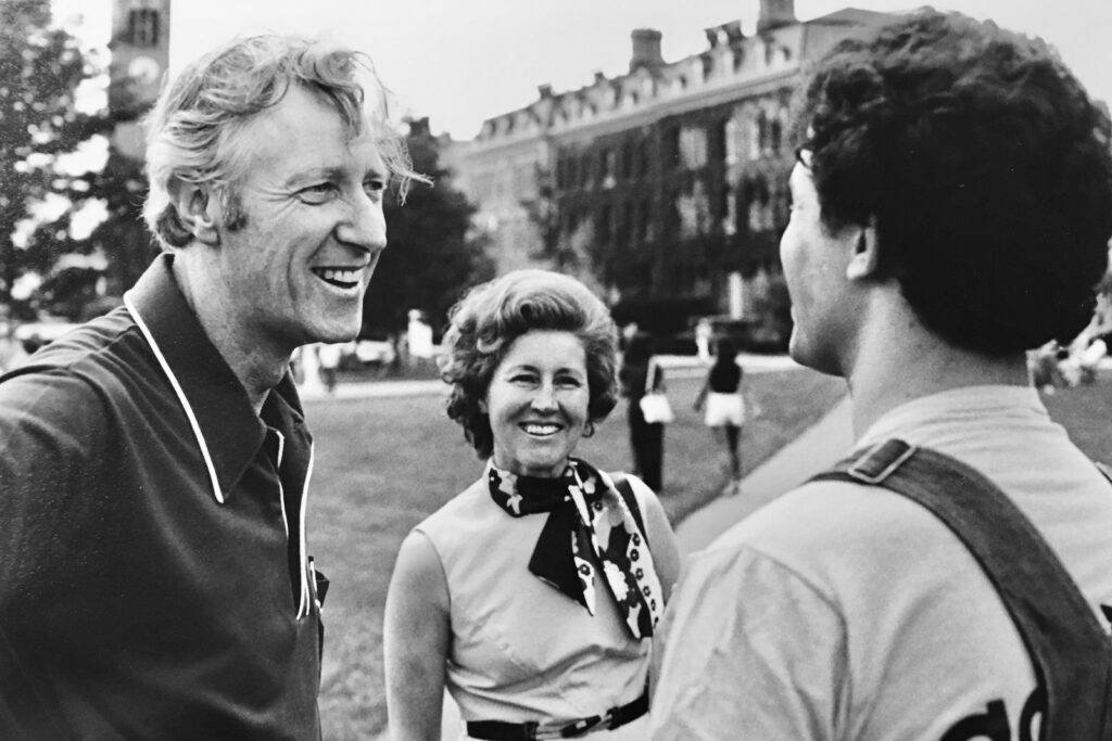 Frank Rhodes and his wife, Rosa Rhodes, speak with a student on the Arts Quad in 1977