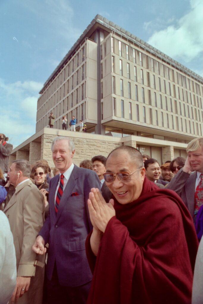 Rhodes walks across campus with the Dalai Lama in 1991