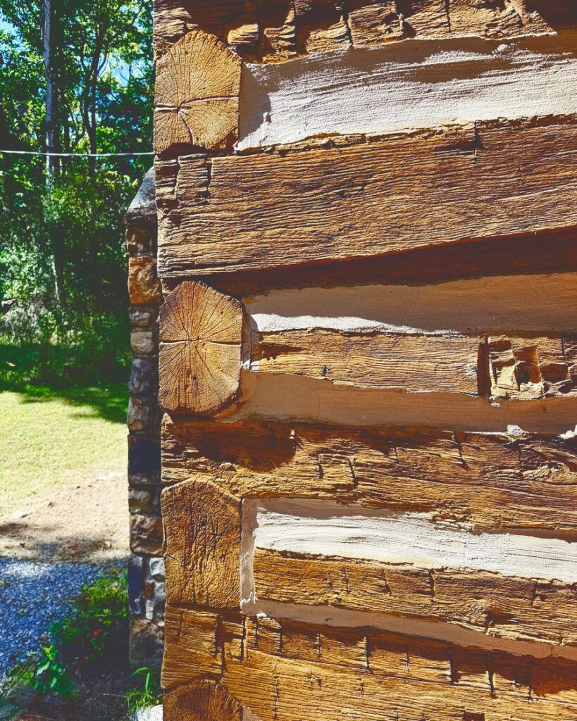the cabin's hand-hewn logs are visible in this corner exterior view