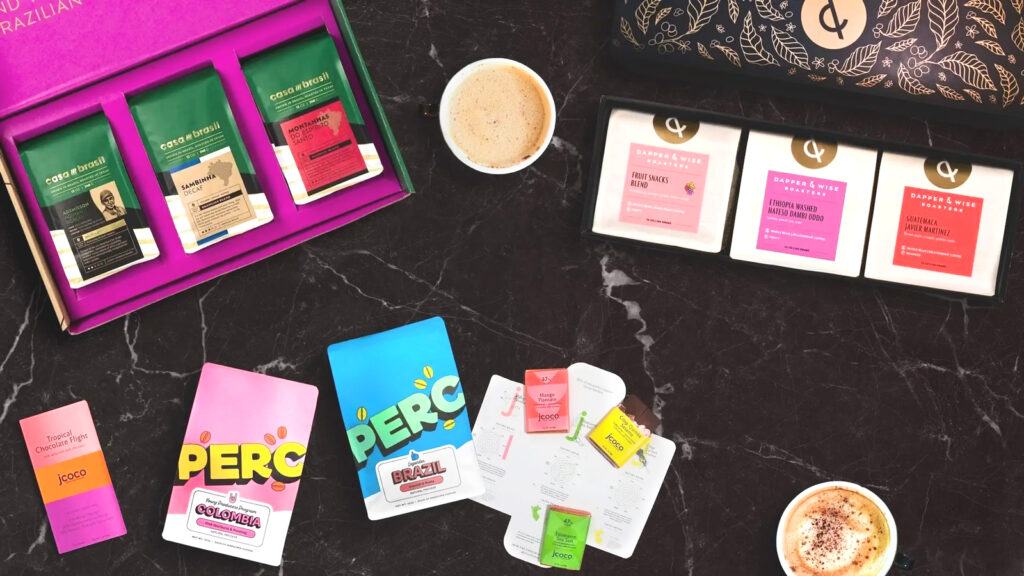 A selection of coffee beans sold by Bean Box, with two cups of coffee