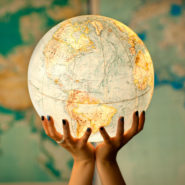Hands holding a glowing globe