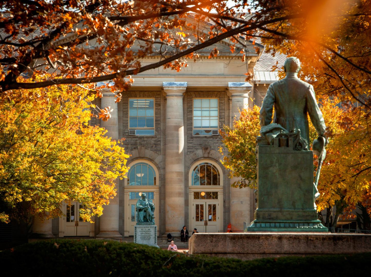 Goldwin Smith Hall and the statue of Ezra Cornell on the Arts Quad in fall.