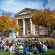 Students on the Arts Quad in fall, near Goldwin Smith Hall.