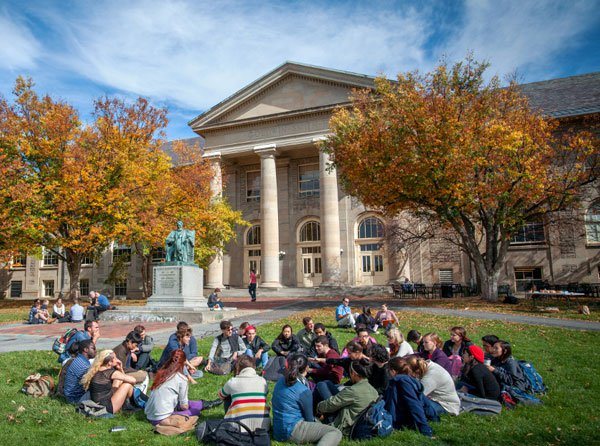 Students on the Arts Quad in fall, near Goldwin Smith Hall.
