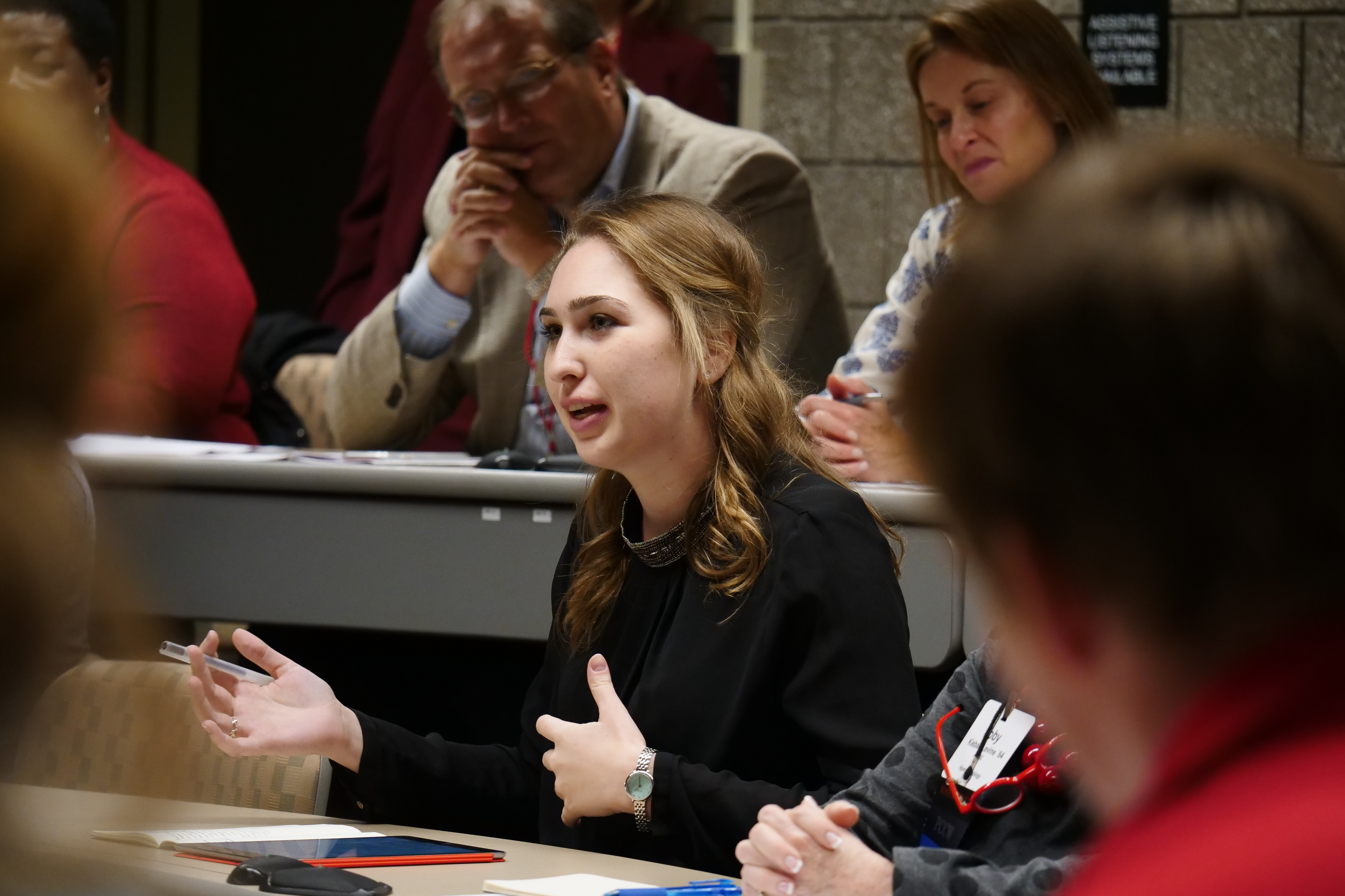 TCAM attendees sit with students in an ILR class.