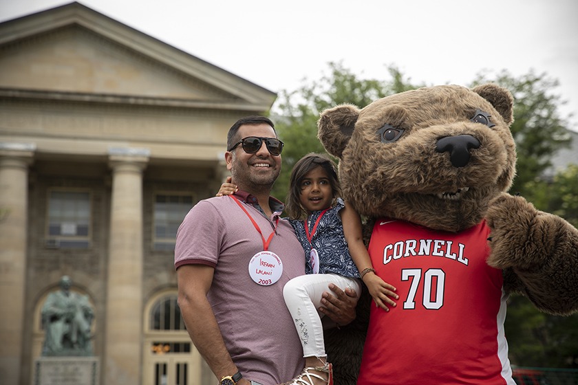 Irfaan Lalani ’03 and his daughter meet Touchdown the Bear.