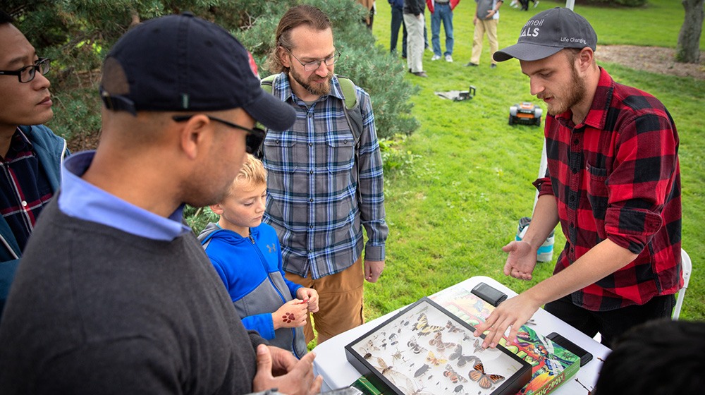 Jacob Gorneau ’20, a member of Snodgrass and Wigglesworth, Cornell’s undergraduate entomology club, tells visitors about butterflies.