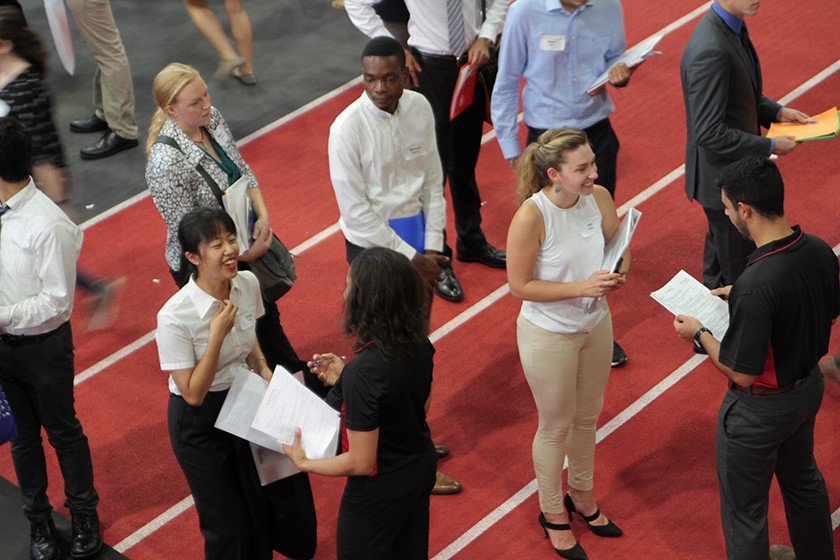 Students conversing with prospective employers at 2018 University Career Fair Days in Barton Hall.