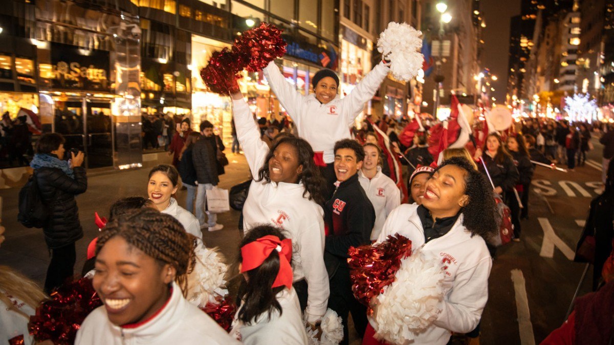 The Cornell cheerleading team parades down Fifth Avenue.