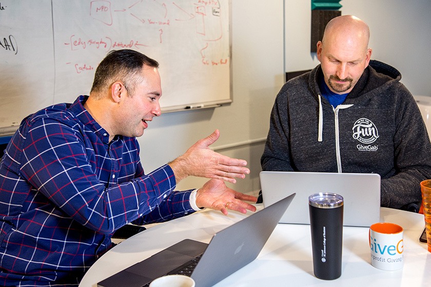 Aaron Godert Charlie Mulligan discuss a problem over laptops.