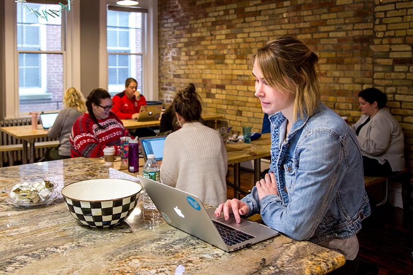 GiveGab employee Jaclyn Saksa works on her laptop in the GiveGab headquarters