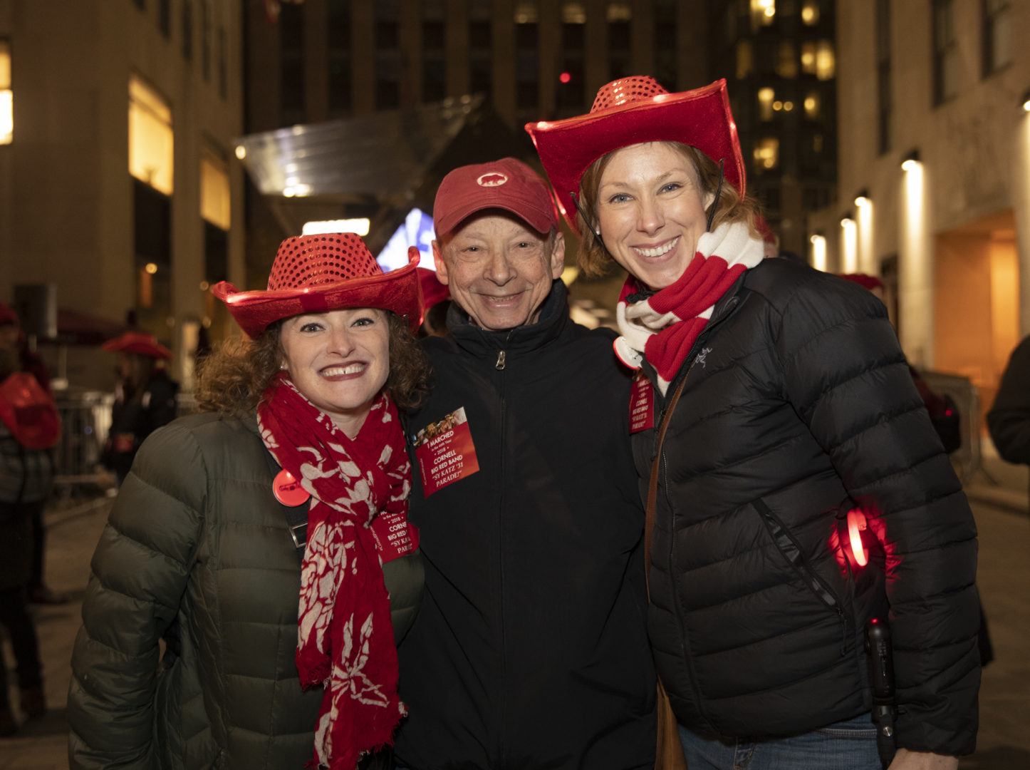 Cornell AAD staff and alumni wear red hats at the Sy Katz Parade