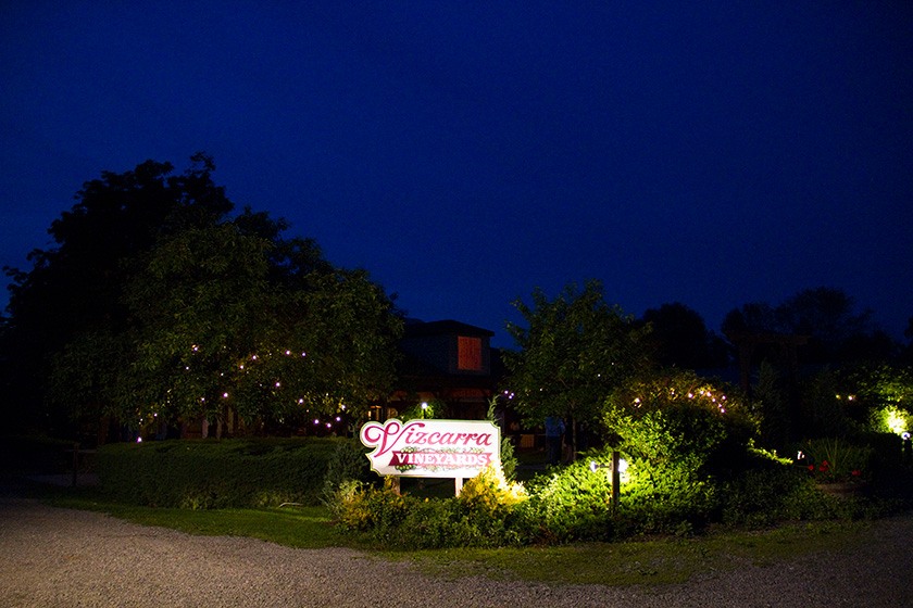 The sign of Vizcarra Vineyards, lit up after sunset