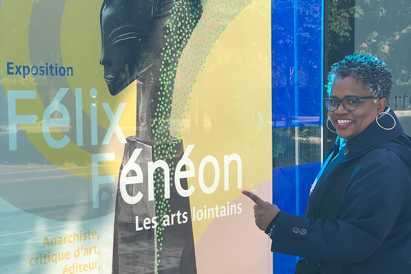 Angelica Allen-McMillan points to an exhibit poster at Le Musee D’Orsay.