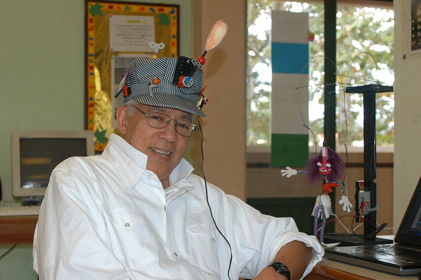 John Galinato wearing a striped hat decorated with a lightbulb and gadgets