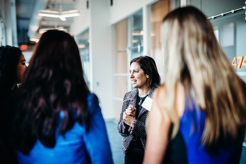 Lorette Simon Gross chatting with three students