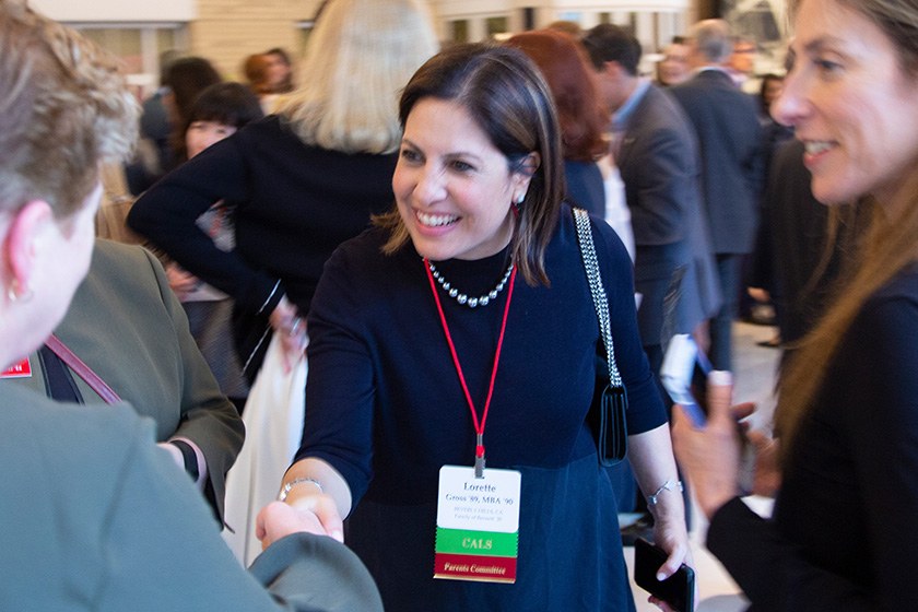 Lorette Simon Gross, reaching out to shake a hand.