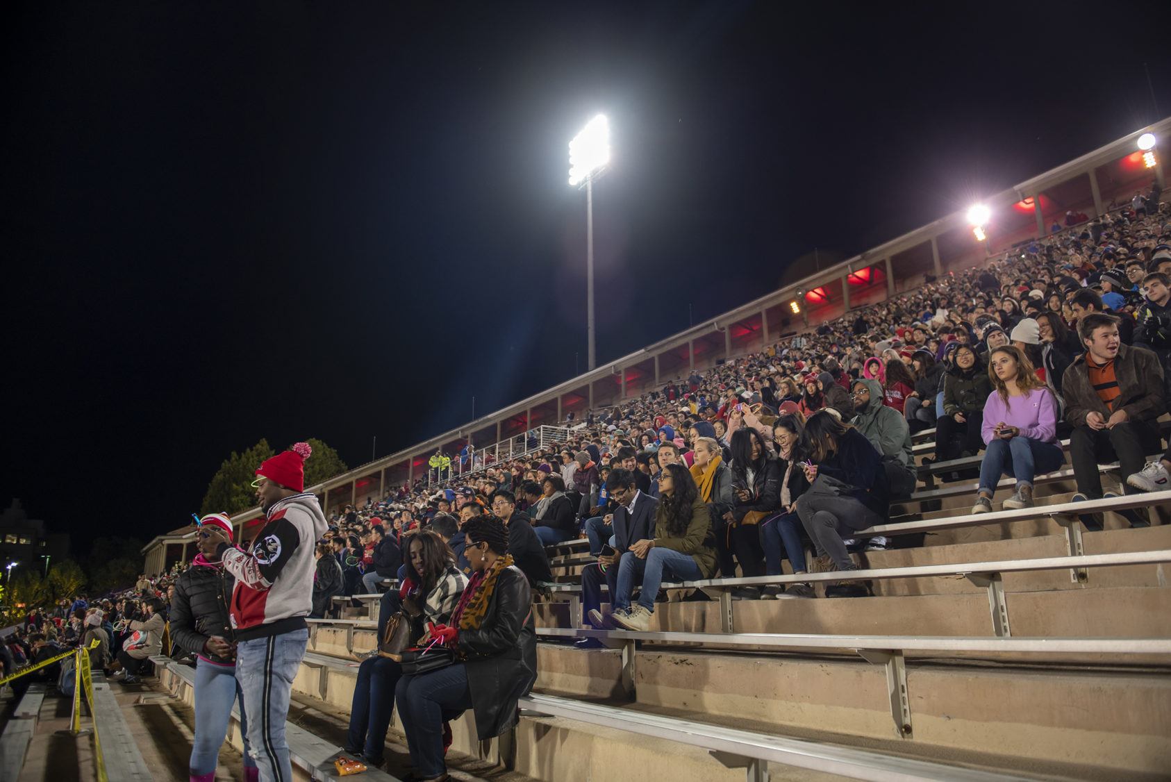 The Schoellkopf Field stands, full of spectators at night.