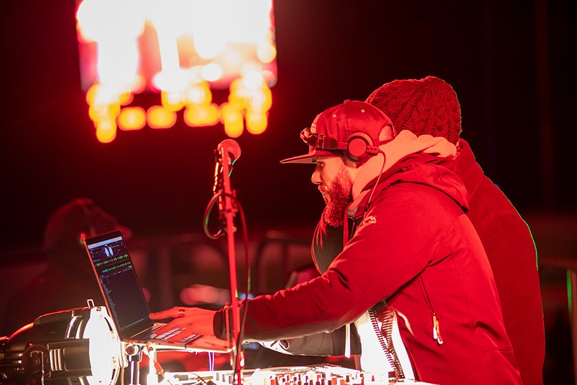 DJ Ben Ortiz, with headphones and mixing board