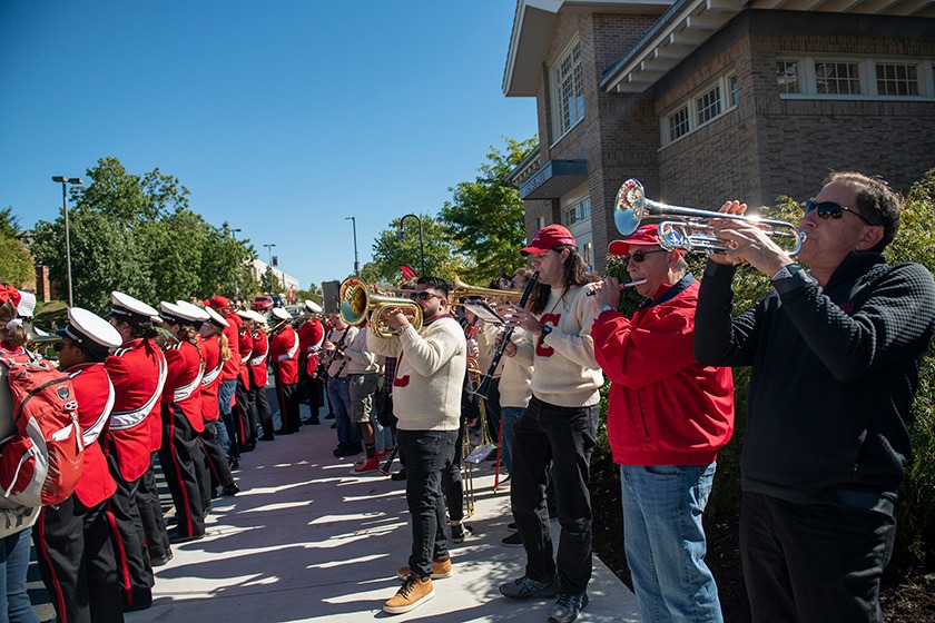 Two rows of band musicians playing instruments