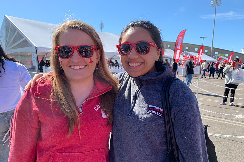 Two young women wearing sunglasses and smiling