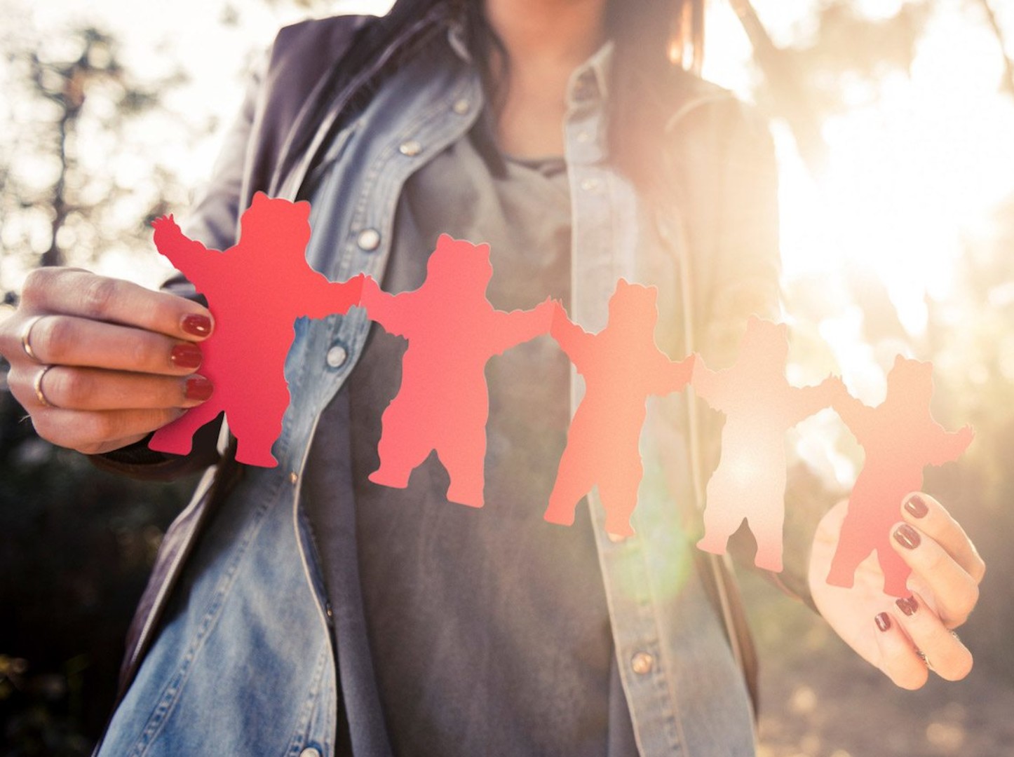 Woman holding red bear cut outs