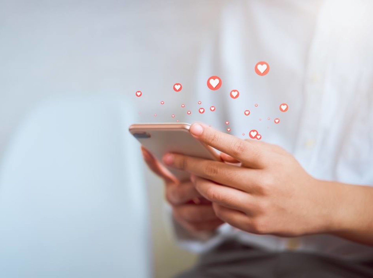 Woman hand using smartphone and show heart icon social media.