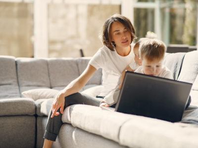 mother and two children in front of a laptop