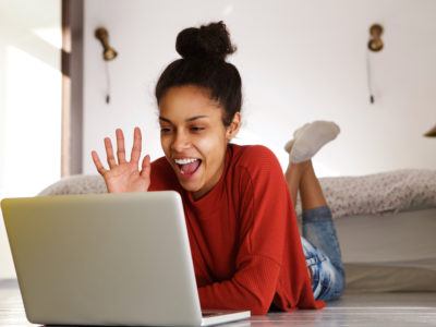 Smiling woman making video call on laptop