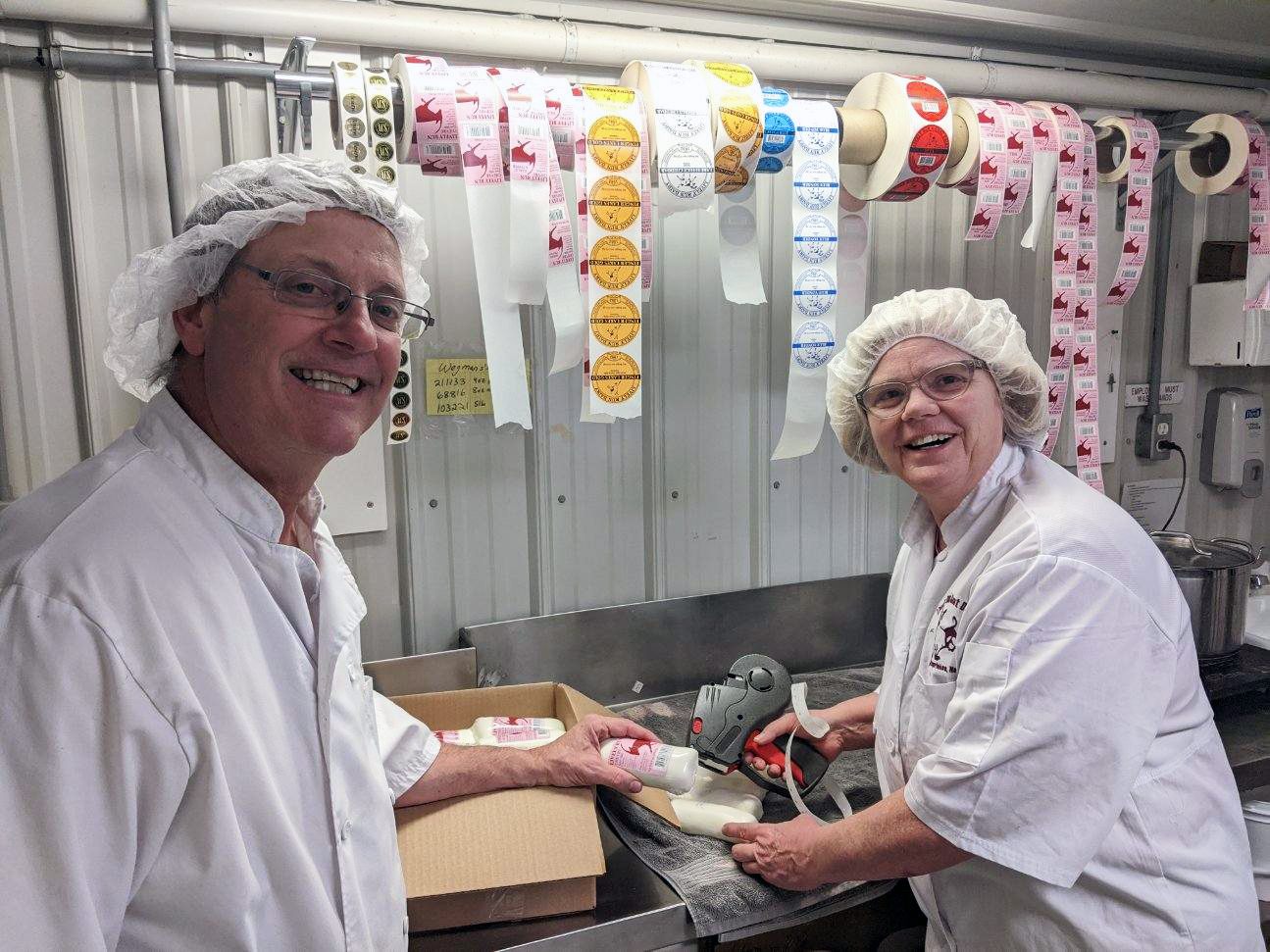 Steve and Susanne Messmer packaging cheese donations.