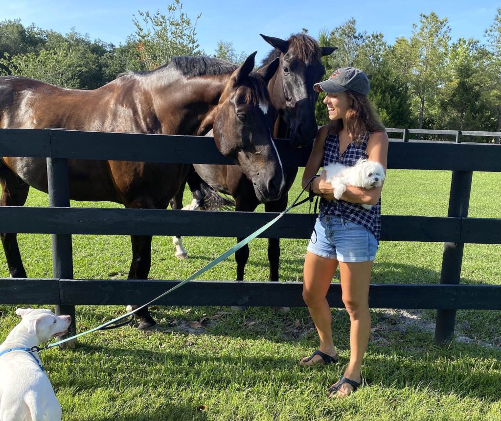 Alexandra enjoying dog walks and spending quality time with her family's horses, Paulie (left) and Q (right).