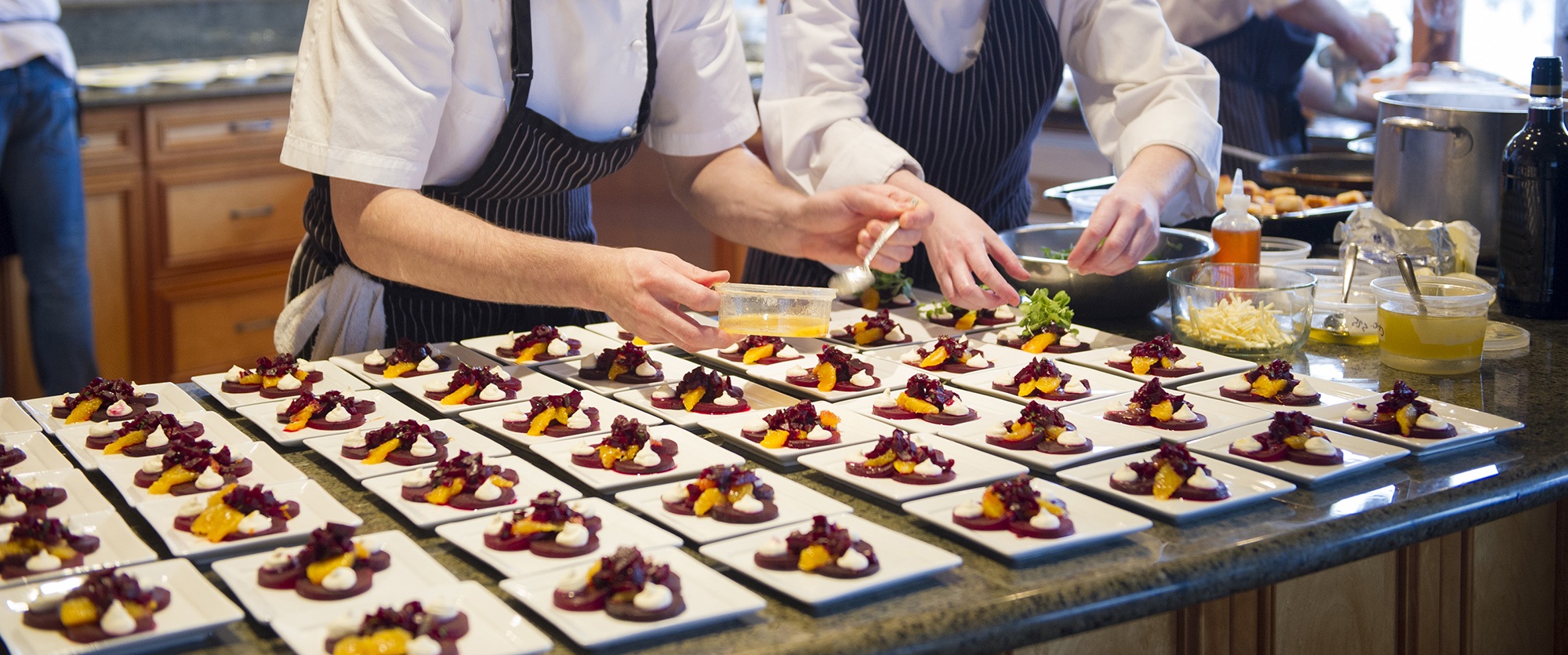 Chefs plating up a beet salad