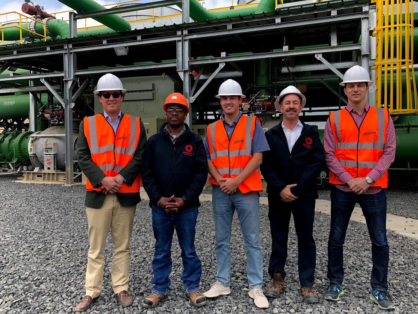 Jones (far right) and colleagues at Ormat’s geothermal complex in Kenya. Jones and his team helped arrange $310 million in financing for this project.