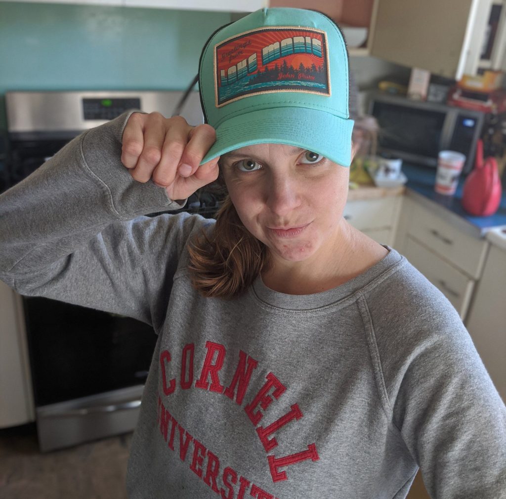 Hannah in a John Prine cap. “The loss of John Prine hit my family hard, as he has been a constant companion on road trips and family outings. His way of distilling this complicated world provided a sense of comfort,” she says.