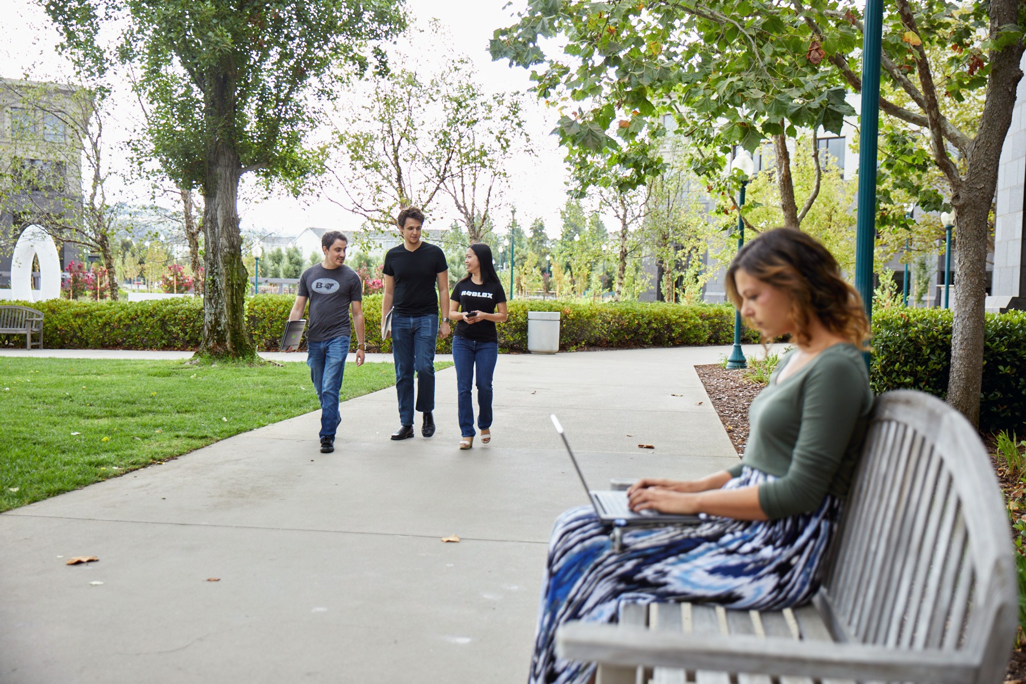 Employees walk between campus buildings at Roblox Headquarters in San Mateo, California.