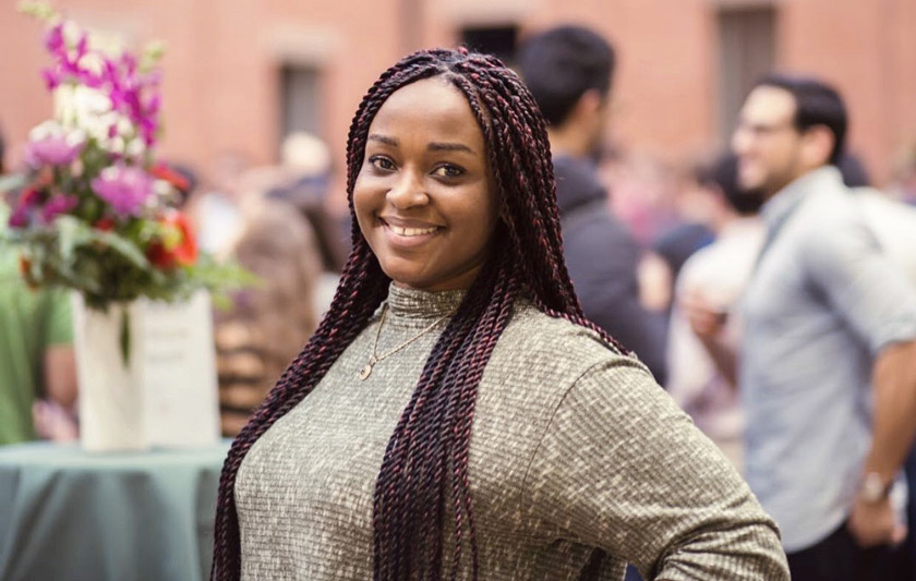 Rozy Amponsah in the Sage Hall Atrium attending an MBA networking event.