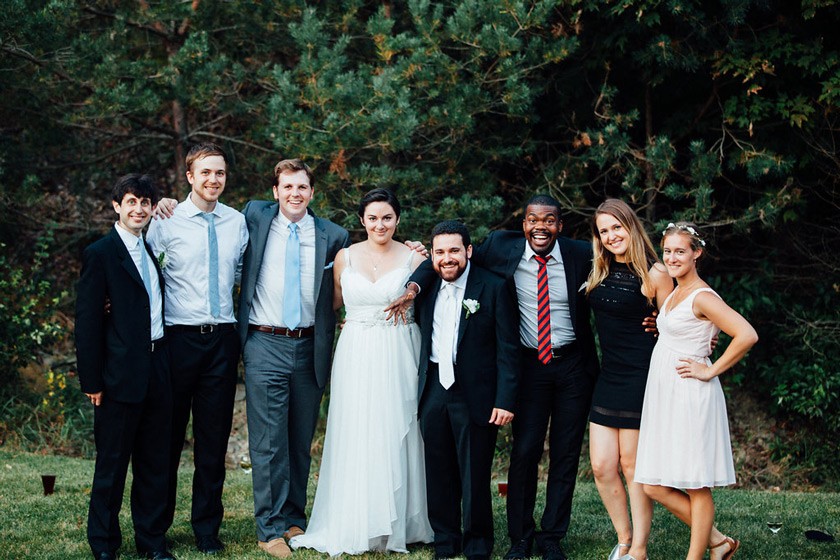 (left to right) Zach Glass ’09, Alec Story ’12, Ian Harkins ’11, Jess Kelley-Madera ’12, Christian Kelley-Madera ’10, Paul Notice (the only non-Cornellian in the photo), Julie Reed ’12, and Anya Gibian ’12 at the Kelley-Madera wedding in 2015.