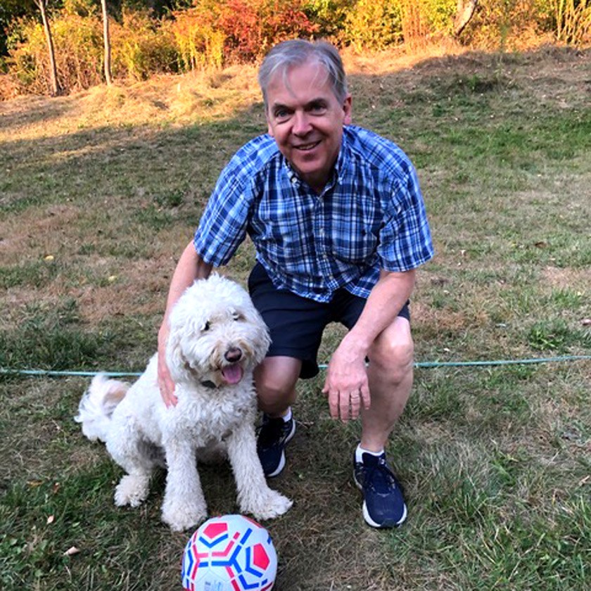 Steve Hilgartner enjoys playing “dog soccer” with Lulli, the course mascot.