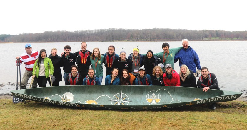 The Cornell Concrete Canoe team at competition in 2019 with their boat, Meridian.