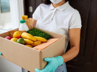 person carrying box full of food