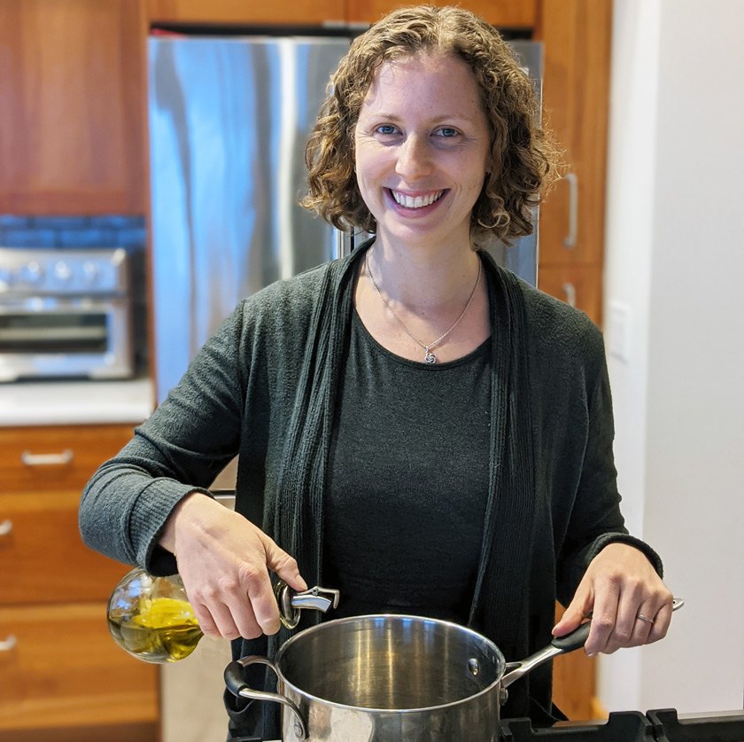 Nutritionist Erin Harner pouring extra virgin olive oil in a pan to make soup.