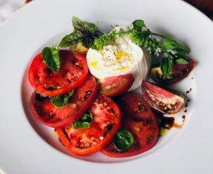 One of Blake’s favorite culinary creations using his homegrown produce: Cherokee Purple, Mortgage Lifter, and Black Prince heirloom tomatoes, burrata, and flowering basil