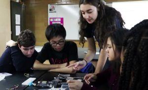 Karina in high school, working with a group of students to 3D print toys for kids at the Ronald McDonald House.