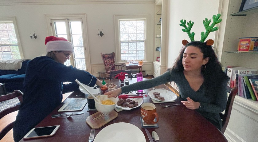 Maya and her roommate Claire Noack ’20 on Christmas morning 2020 enjoying a brunch of eggs, sausage, and French toast casserole made by Claire. Credit: Jay Bender ’20