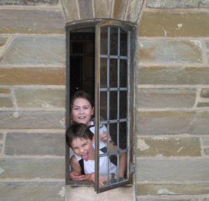 enata Geer's ’82 children, Maya and Lukas, pose in a window at Willard Straight Hall in 2010