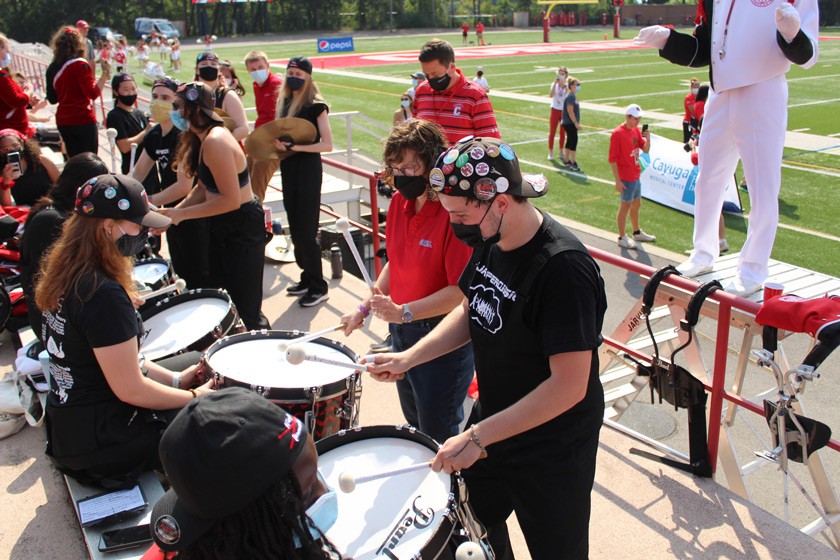 President Martha Pollack performing with the BRMB during the Homecoming football game on Schoellkopf Field.