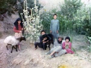 Farid (standing in back) with his family on their land in Logar